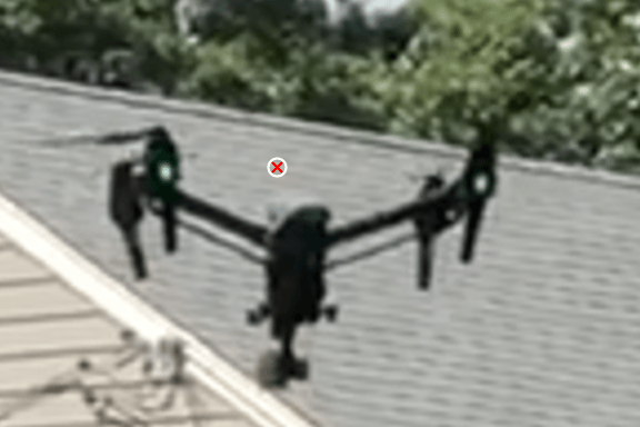 Drone in front of a roof